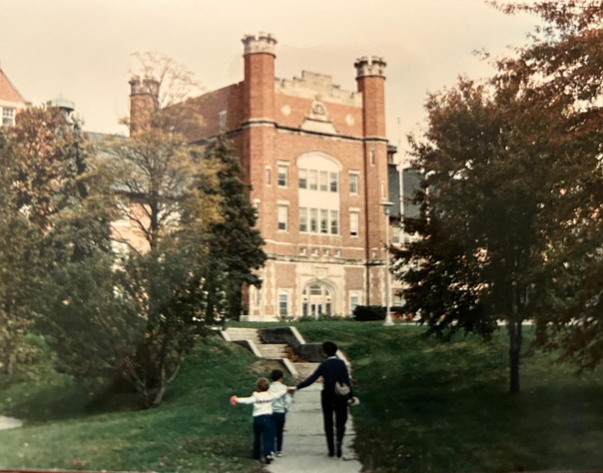 Linda Place leads Ted and his younger sister, Erin, toward the Administration Building during a walk on the Northwest campus in the early 1980s. (Place family photo)